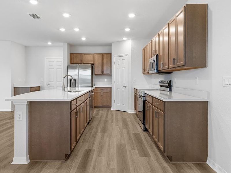 Your spacious kitchen includes quartz counters, 36-inch cabinets, Samsung appliances, and a walk-in pantry.