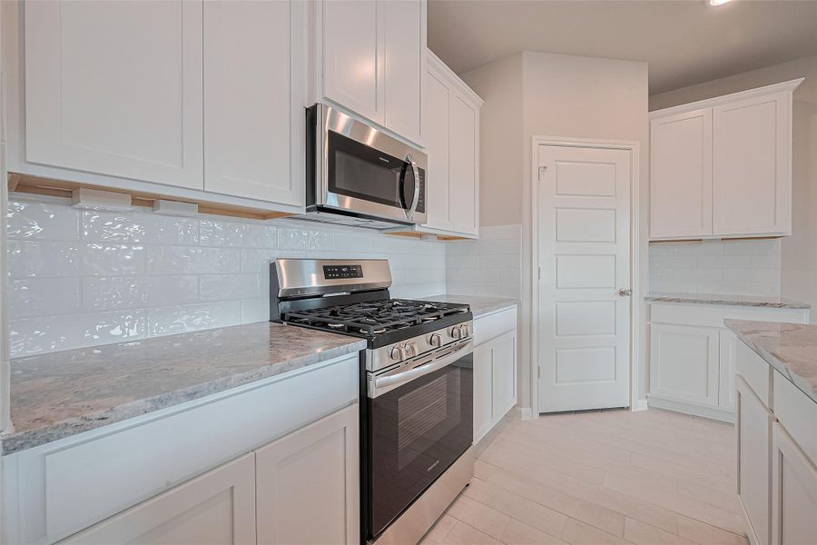 Furnished interior view inside a new home in Sunterra, Katy (Image 7).