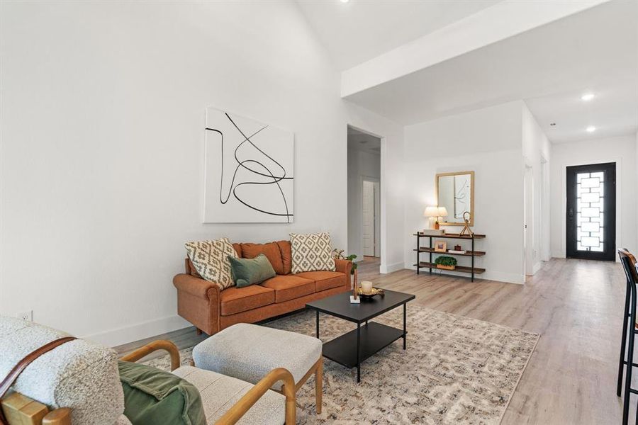 Living room featuring lofted ceiling and light wood-type flooring