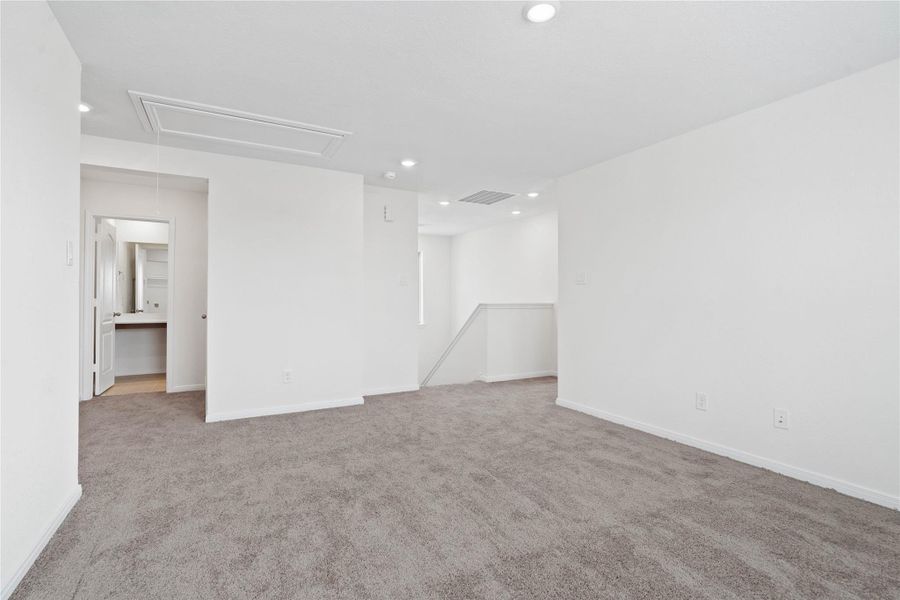 Additional view from the Loft, showcasing the staircase and hallway leading to the secondary bathroom and bedrooms. Additional view from the Loft, showcasing the staircase and hallway leading to the secondary bathroom and bedrooms.