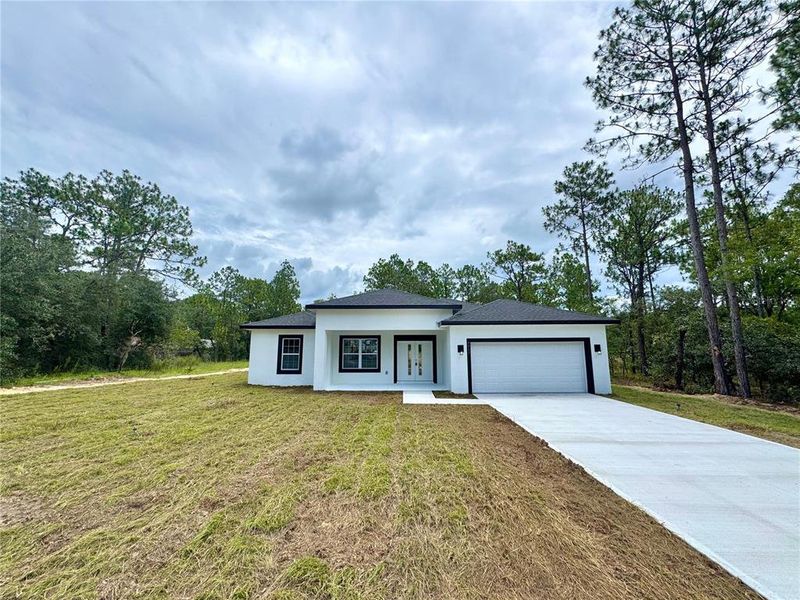 Front exterior of a new home in , Citrus Springs, FL, highlighting curb appeal (Image 18). Front exterior of a new home in , Citrus Springs, FL, highlighting curb appeal (Image 18).
