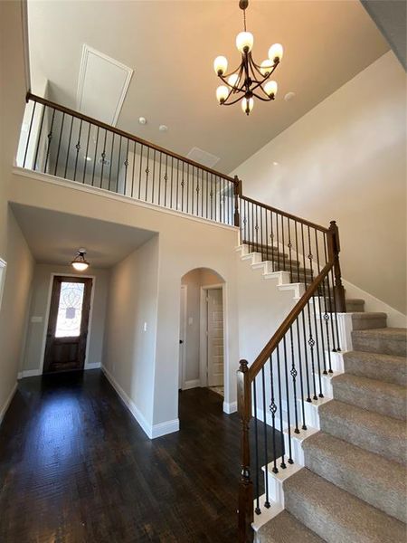 Impressive cathedral entry with wrought iron spindles on staircase and ORB chandelier Impressive cathedral entry with wrought iron spindles on staircase and ORB chandelier