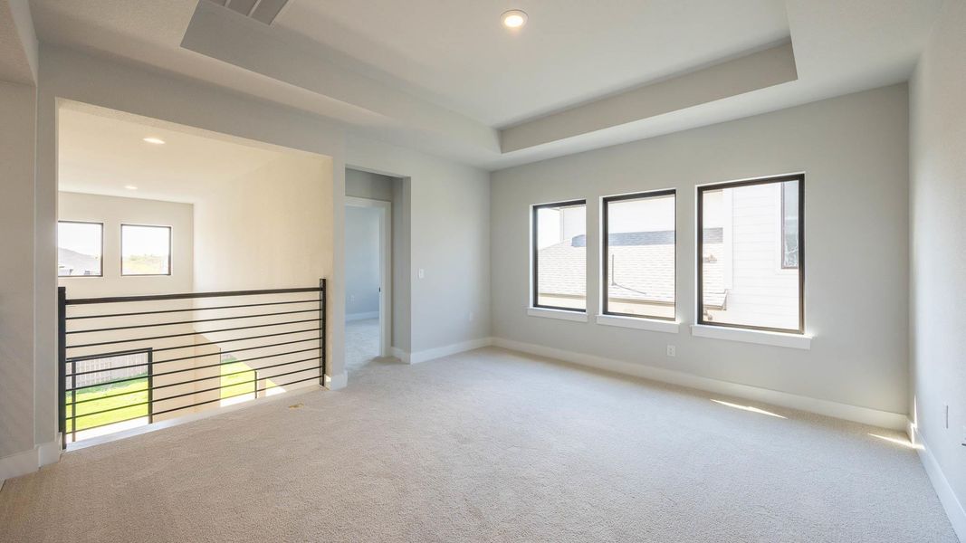 Unfurnished room with carpet, a tray ceiling, and recessed lighting