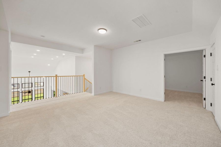 The loft/second living area is well lit and has grand feel from the look out over the living room downstairs.