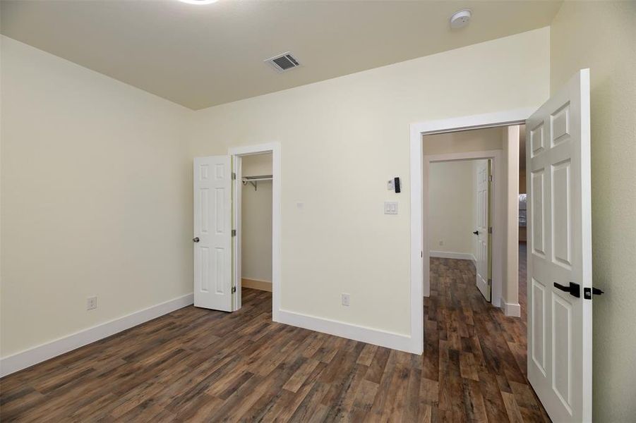 2nd front bedroom is split with ceiling fan and 2 inch blinds.