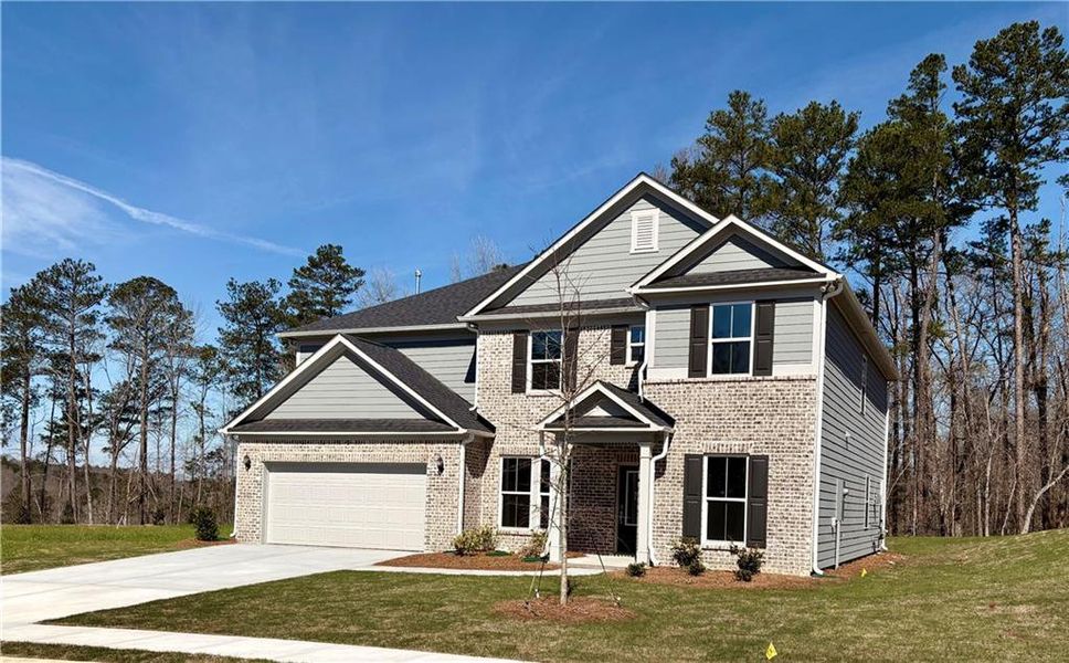 Front exterior of a new home in Riversprings, Dacula, GA, highlighting curb appeal (Image 23). Front exterior of a new home in Riversprings, Dacula, GA, highlighting curb appeal (Image 23).