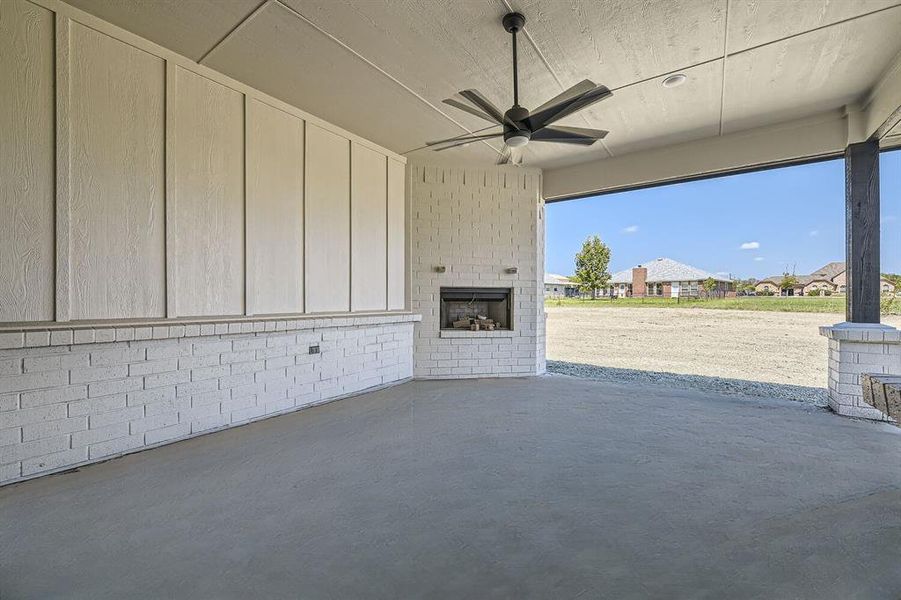 View of patio / terrace with an outdoor brick fireplace and ceiling fan