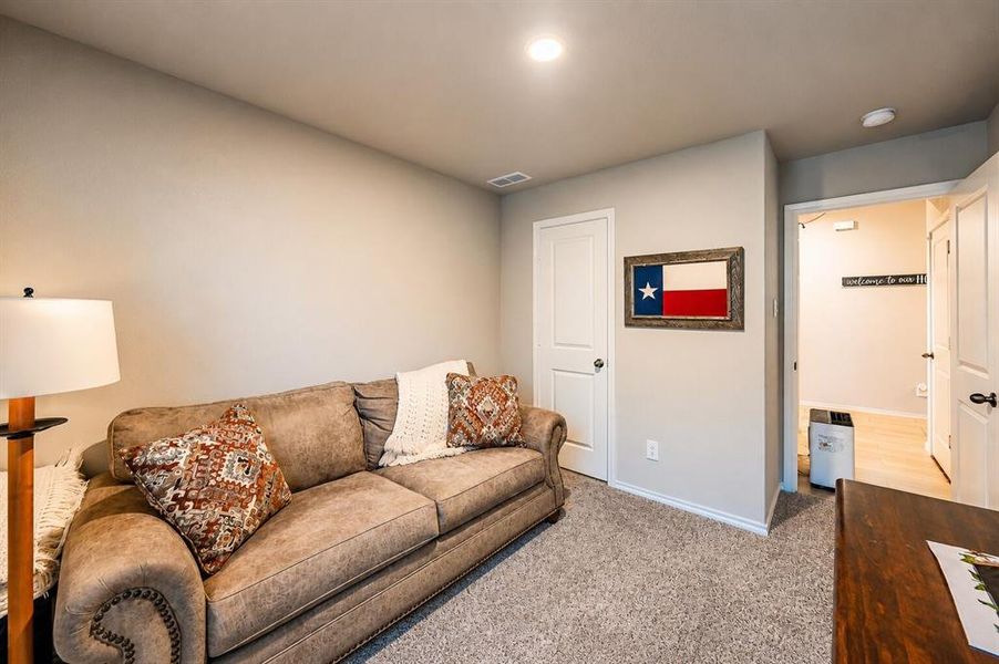 Spacious room featuring neutral-toned walls, recessed lighting, and soft carpet flooring
