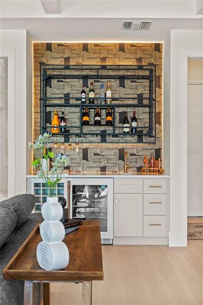 Custom wet bar with sink and wine fridge Custom wet bar with sink and wine fridge