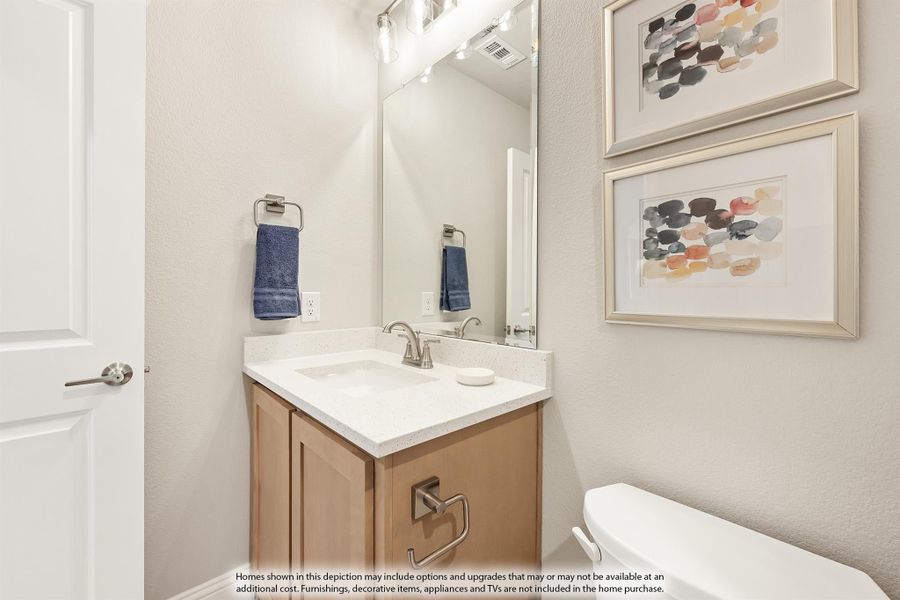 Bathroom with wood vanity, white quartz countertop, large mirror, and toilet with neutral gray walls Bathroom with wood vanity, white quartz countertop, large mirror, and toilet with neutral gray walls