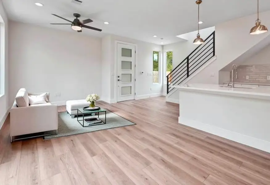 Living area featuring recessed lighting, stairs, light wood-style floors, and a ceiling fan Living area featuring recessed lighting, stairs, light wood-style floors, and a ceiling fan