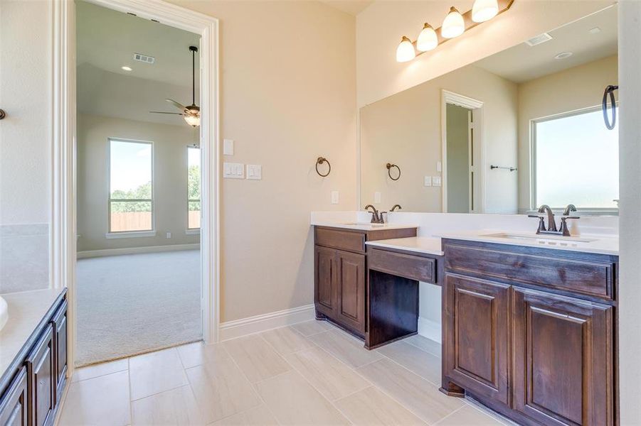 Bathroom featuring tile patterned floors, vanity, and ceiling fan