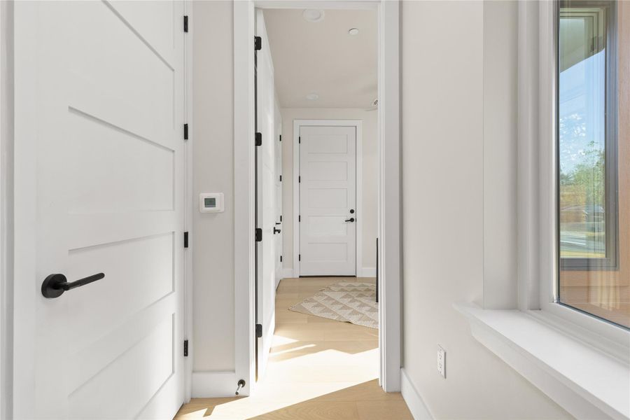 Clean lines and warm hardwood floors define this inviting residential corridor.