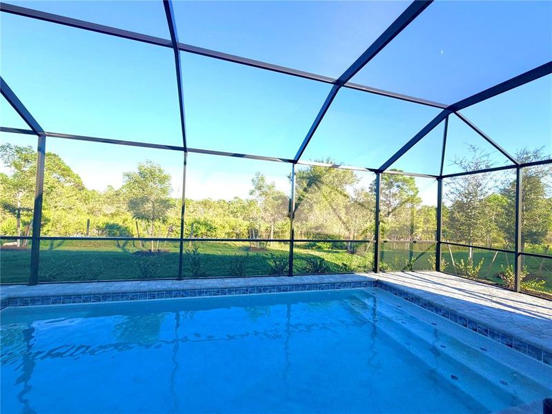 Exterior details and patio area of a home in Island Lakes at Coco Bay: Manor Homes, Englewood (Image 9).