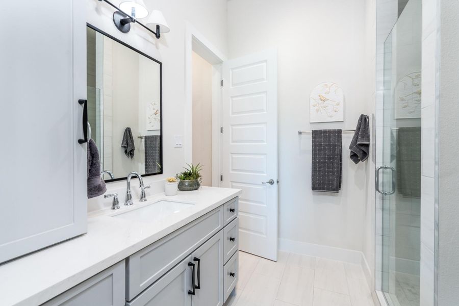 This bathroom features a standing shower and plenty of cabinet space. This bathroom features a standing shower and plenty of cabinet space.