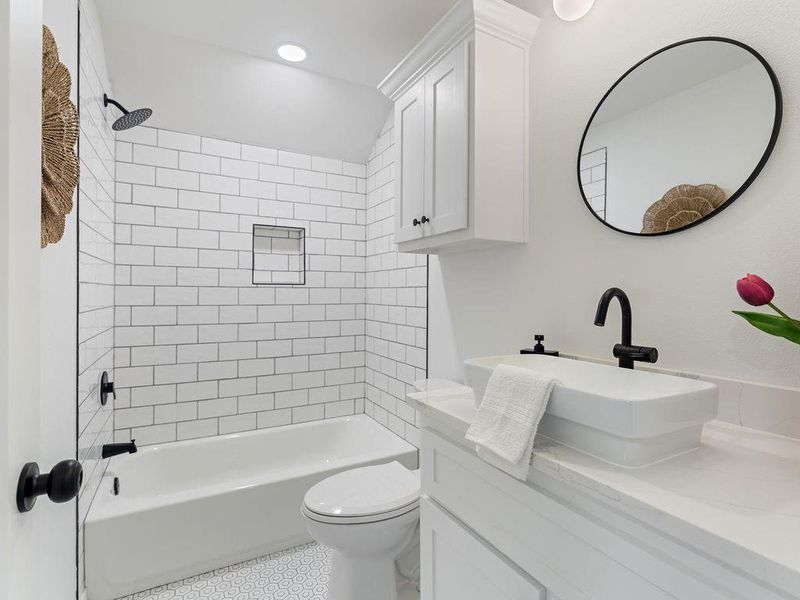 Full bath featuring shower / bath combo and light wood finished floors
