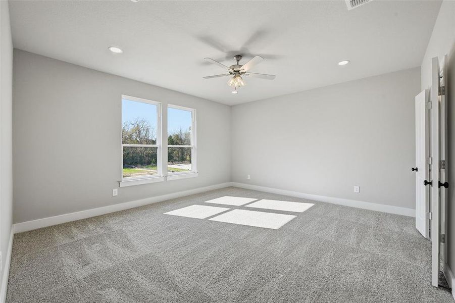 Spare room with light carpet, ceiling fan, and recessed lighting Spare room with light carpet, ceiling fan, and recessed lighting