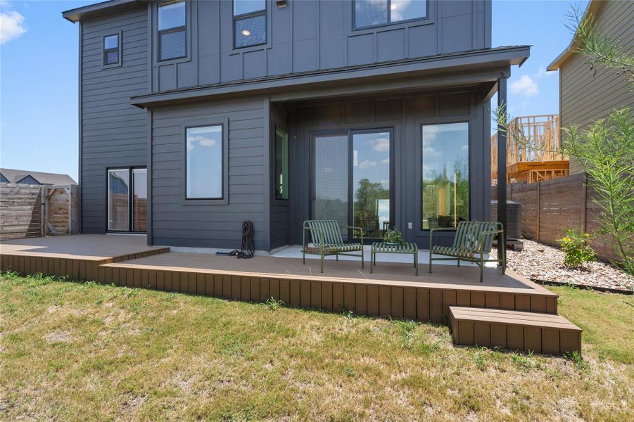 A spacious wooden deck extends from the modern facade, inviting outdoor relaxation and entertainment. A spacious wooden deck extends from the modern facade, inviting outdoor relaxation and entertainment.