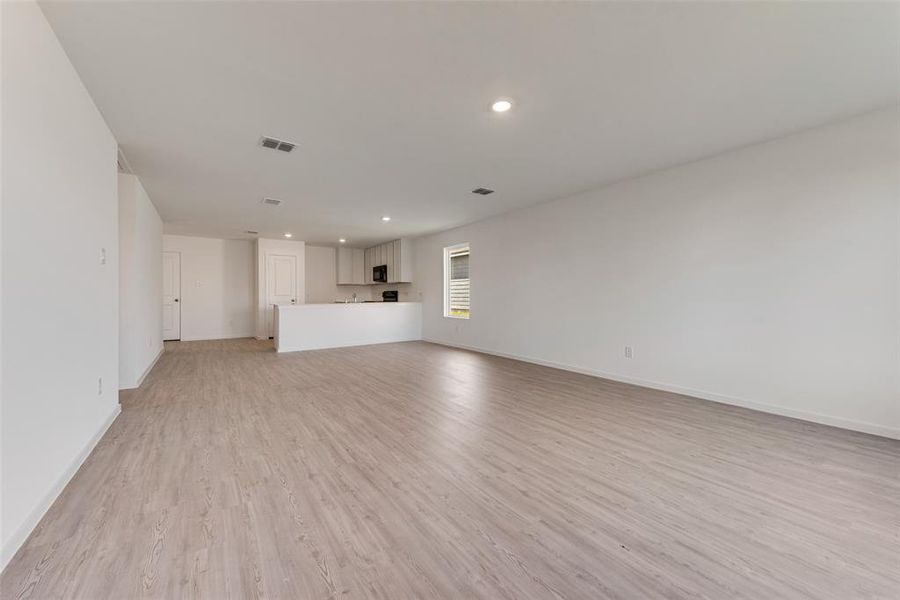 Unfurnished living room with light wood-type flooring