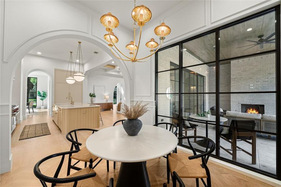 Dining area featuring a contemporary chandelier and light wood-finish flooring