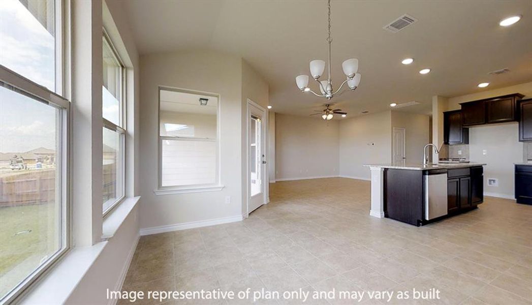 Kitchen featuring a chandelier, pendant lighting, a kitchen island with sink, dark brown cabinets, and open floor plan Kitchen featuring a chandelier, pendant lighting, a kitchen island with sink, dark brown cabinets, and open floor plan