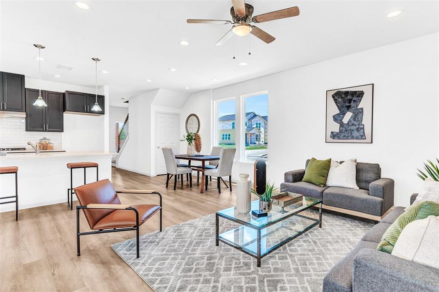 Living room with light wood-type flooring and ceiling fan