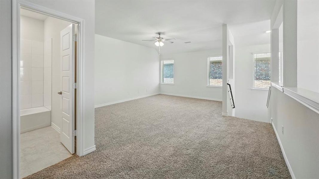 Spare room with light colored carpet and a ceiling fan Spare room with light colored carpet and a ceiling fan