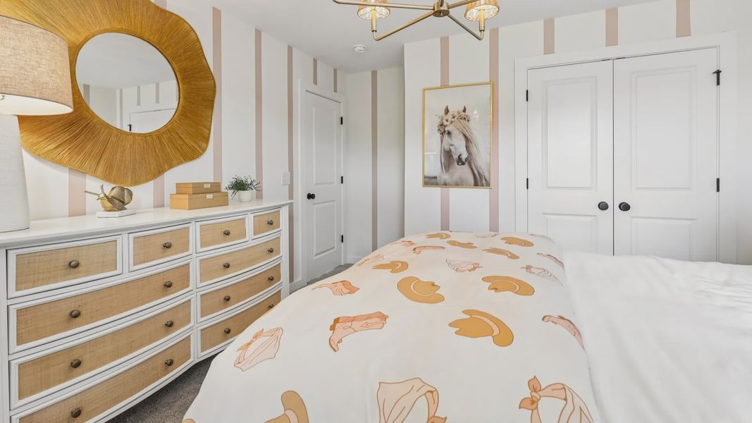 Secondary bedroom with carpet, closet, and window