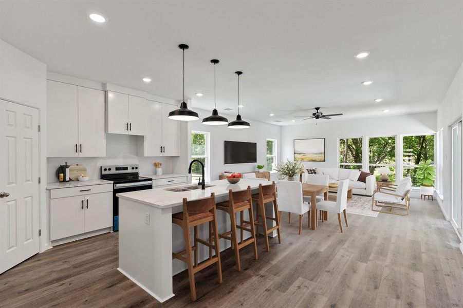 Kitchen with a sink, electric stove, recessed lighting, open floor plan, and ceiling fan Kitchen with a sink, electric stove, recessed lighting, open floor plan, and ceiling fan