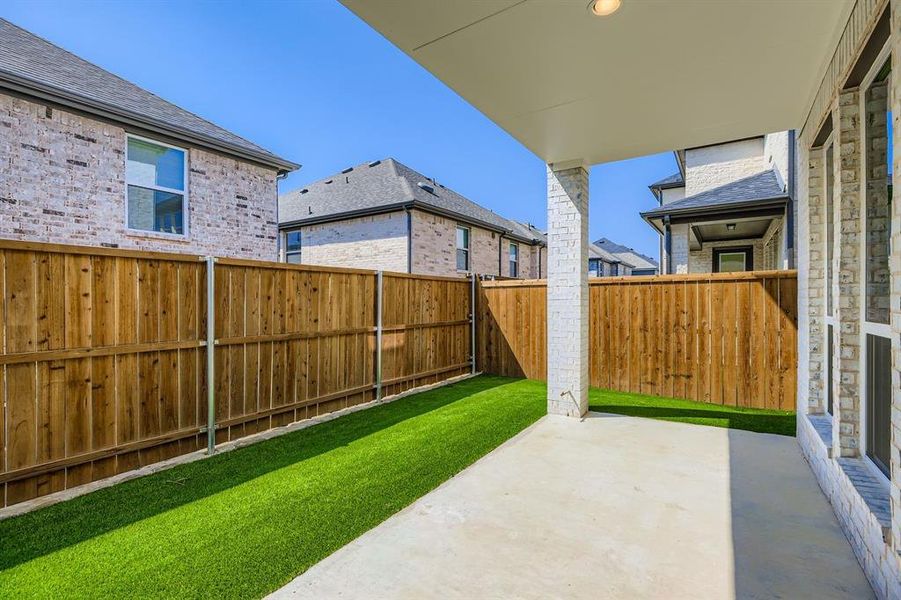 Fenced backyard with a patio