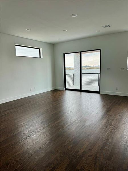 Spare room with dark hardwood / wood-style flooring