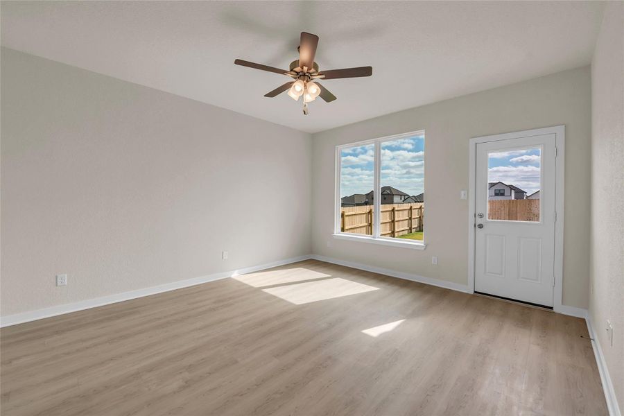 Unfurnished room with light wood-type flooring and a ceiling fan