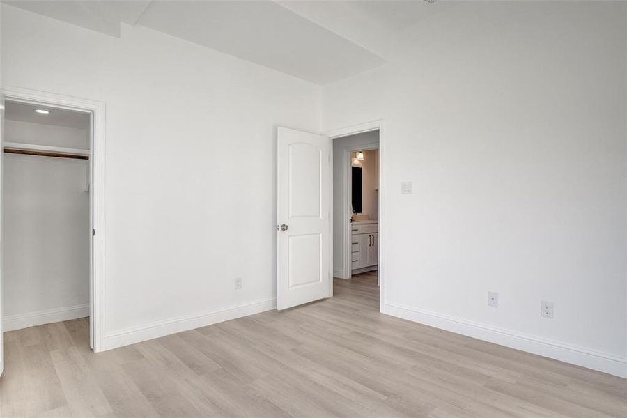 Unfurnished bedroom featuring light wood-style floors and a closet Unfurnished bedroom featuring light wood-style floors and a closet