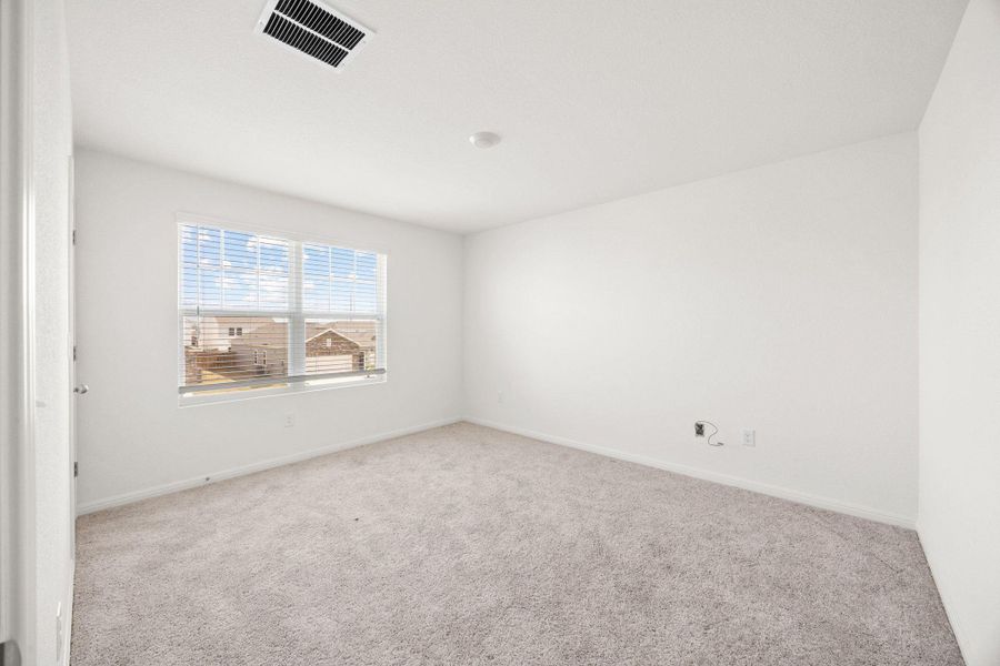 Spare room featuring carpet and baseboards