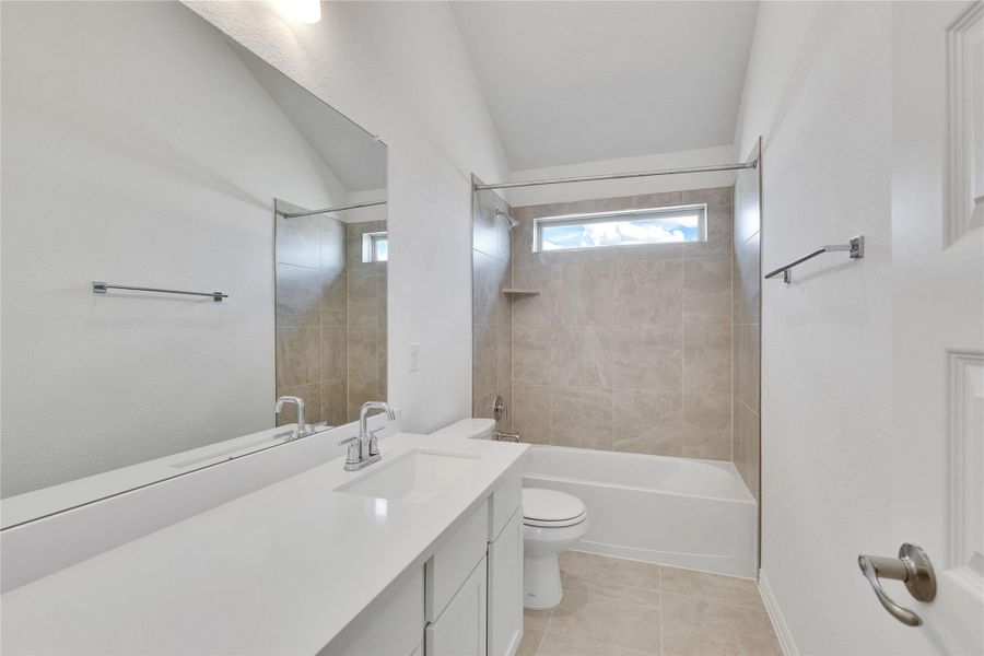 Bathroom featuring shower / bathtub combination, vanity, and light tile patterned flooring Bathroom featuring shower / bathtub combination, vanity, and light tile patterned flooring