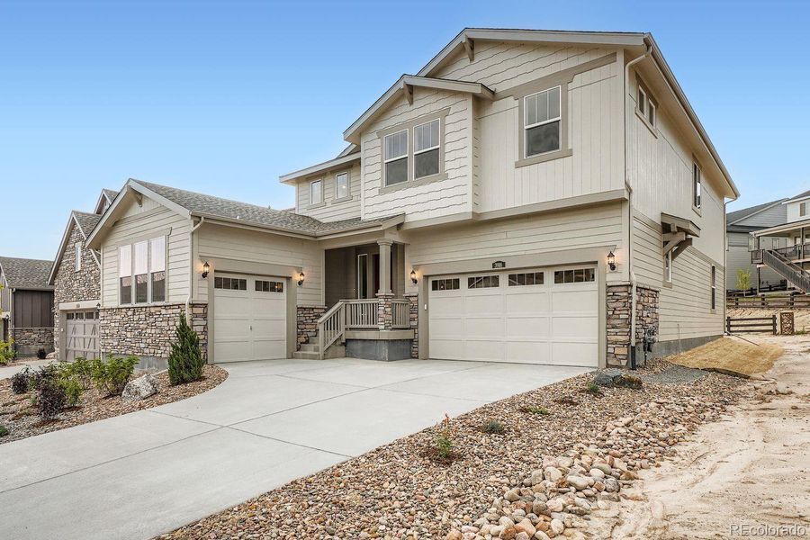 Front exterior of a new home in Macanta: The Grand Collection, Castle Rock, CO, highlighting curb appeal (Image 1).