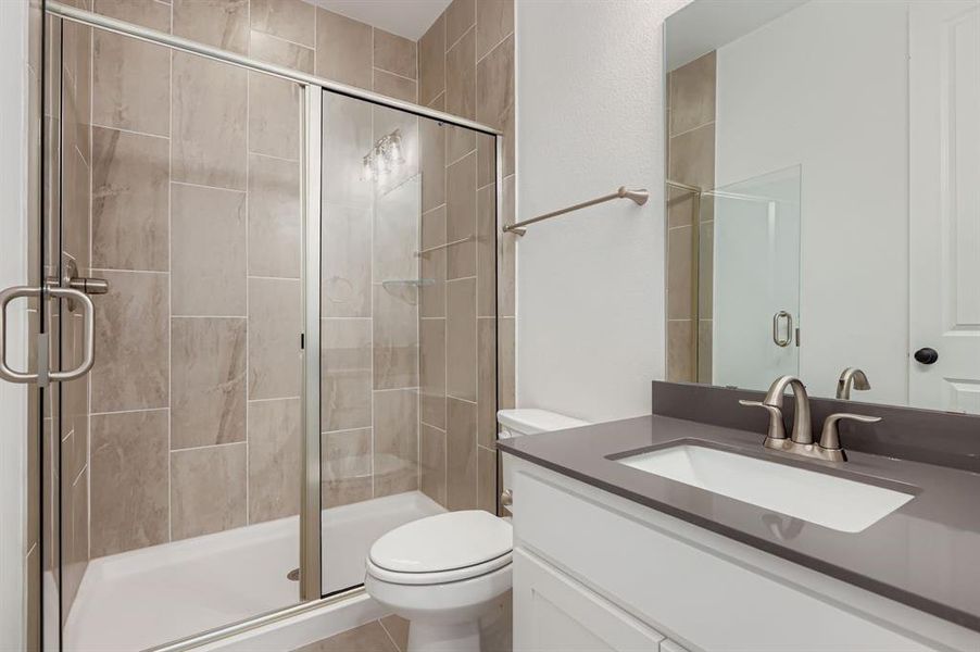 Bathroom featuring vanity and a stall shower Bathroom featuring vanity and a stall shower