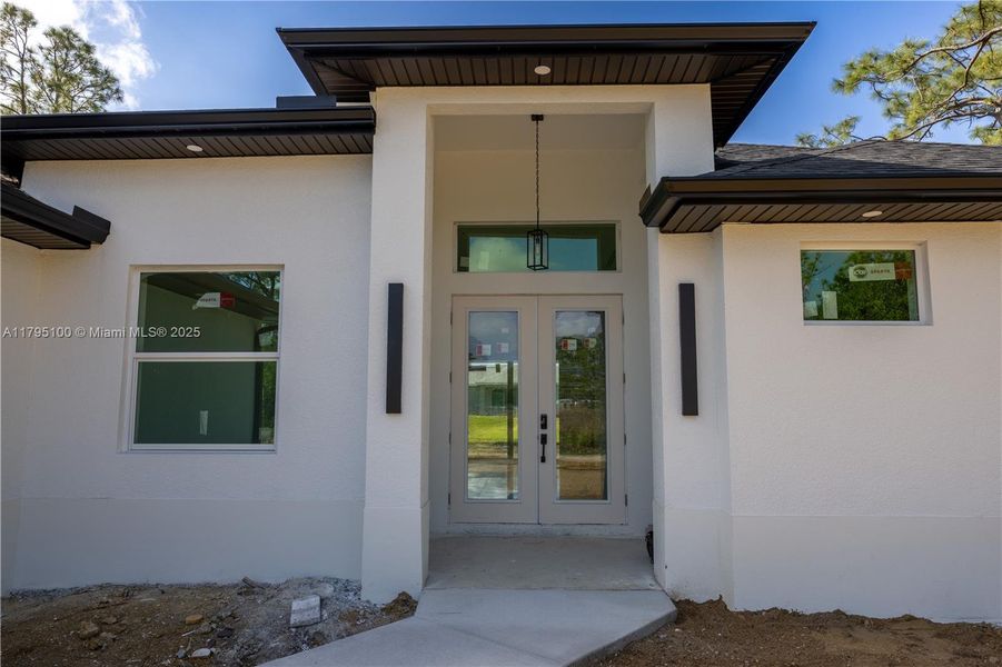 Front exterior of a new home in , Lehigh Acres, FL, highlighting curb appeal (Image 15).