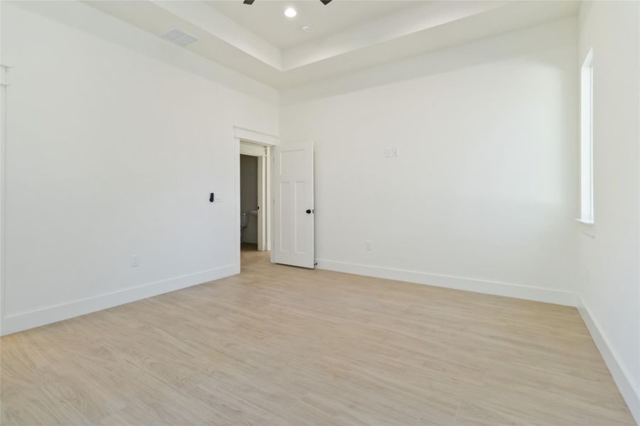 Primary bedroom with tray ceiling Primary bedroom with tray ceiling