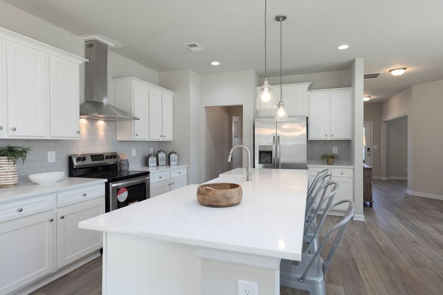 The gourmet kitchen features a large center island and lots of cabinet space