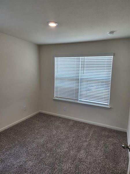 Carpeted spare room with recessed lighting and a smoke detector