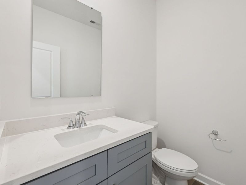 The half bathroom includes a storage vanity for a cleaner look to store your essentials. The half bathroom includes a storage vanity for a cleaner look to store your essentials.