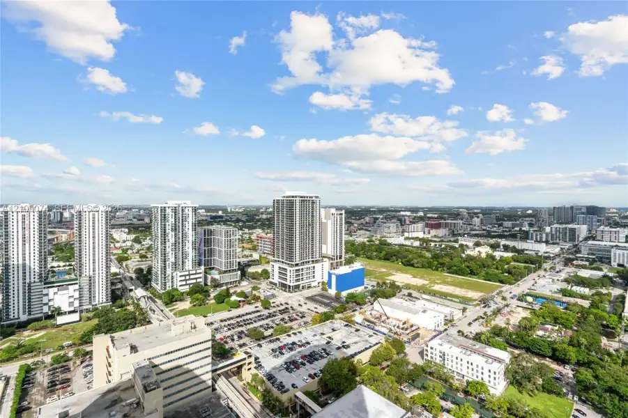 Elevated urban perspective featuring a metropolitan cityscape, high-rise architecture, and expansive horizon