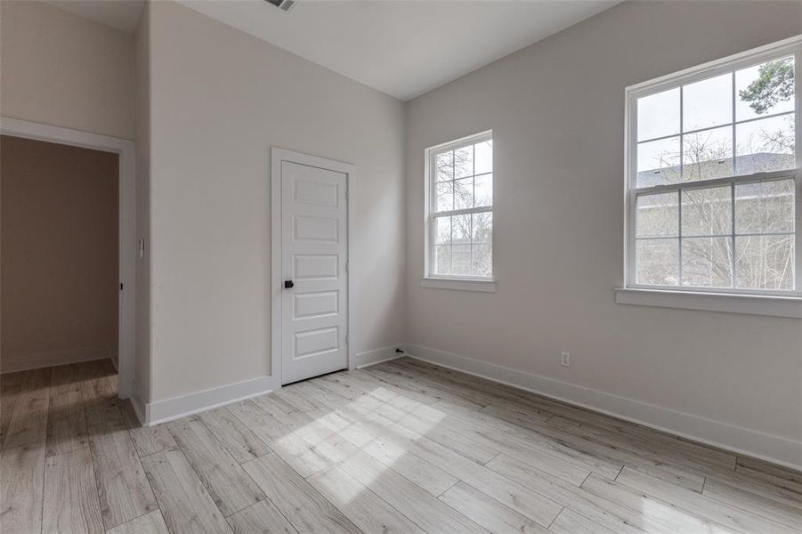 Empty room with baseboards and wood finished floors