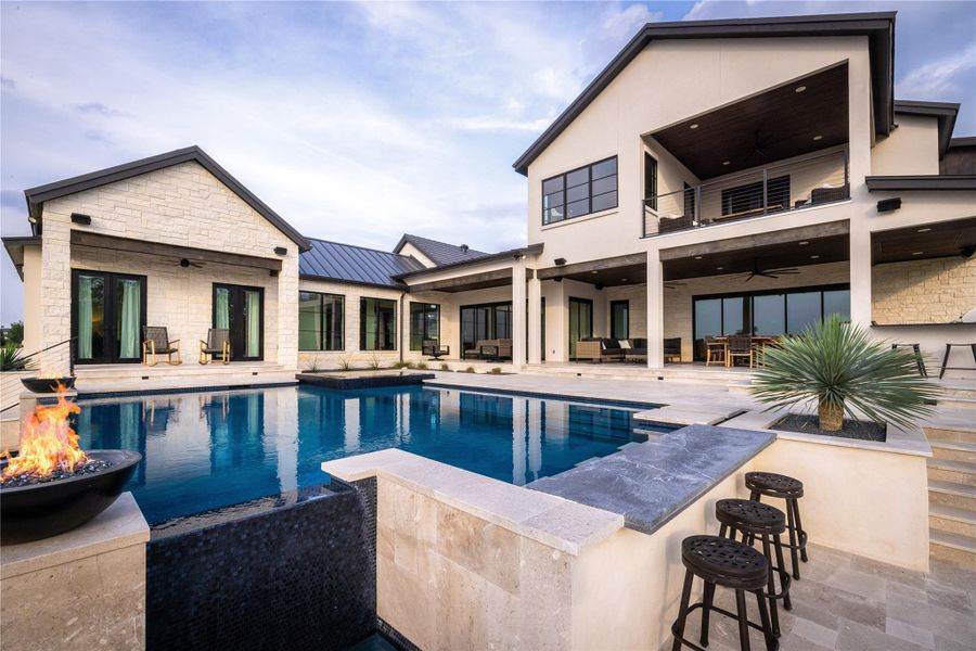 View of swimming pool with a fire pit, a patio area, and ceiling fan