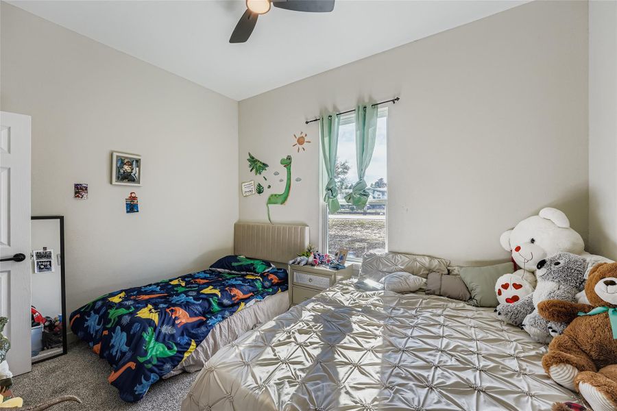 Bedroom with carpet, ceiling fan, and radiator heating unit Bedroom with carpet, ceiling fan, and radiator heating unit