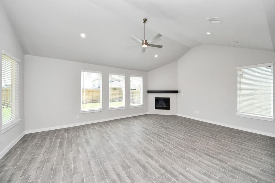 Welcome family and guests to your charming living room! With its high ceilings, recessed lighting, ceiling fan, custom paint, beautiful flooring, and large windows that let in abundant natural light, this room is perfect for gatherings. Sample photo of completed home with similar floor plan. Actual colors and selections may vary. Welcome family and guests to your charming living room! With its high ceilings, recessed lighting, ceiling fan, custom paint, beautiful flooring, and large windows that let in abundant natural light, this room is perfect for gatherings. Sample photo of completed home with similar floor plan. Actual colors and selections may vary.