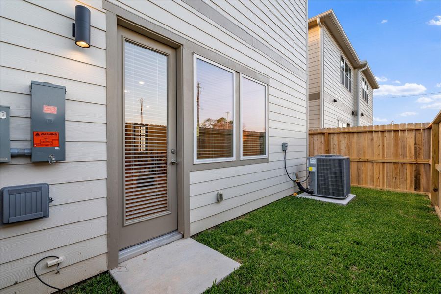 Private fenced backyard with manageable green space and direct access from the home.