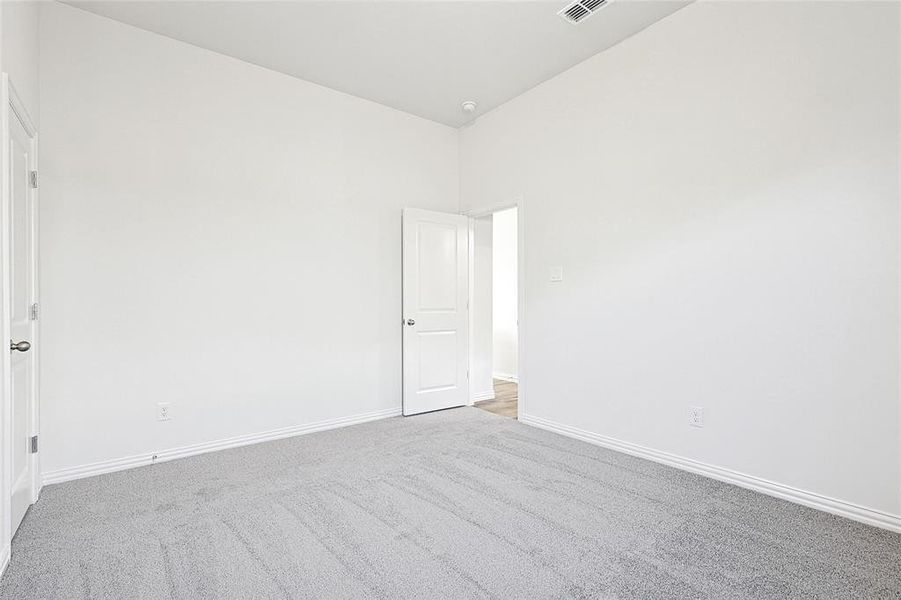 Carpeted spare room with baseboards Carpeted spare room with baseboards