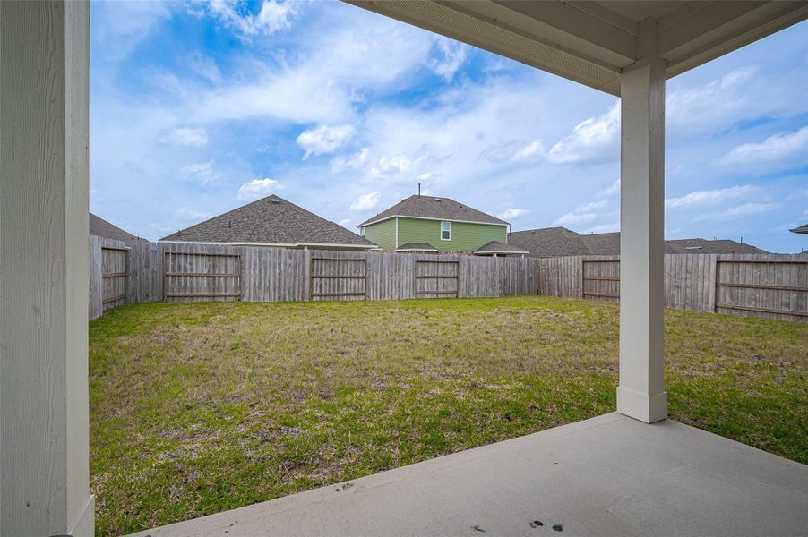 Wide backyard with privacy fencing.
